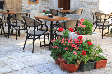 Fototapeta na wymiar A small street cafe in the old medieval city.