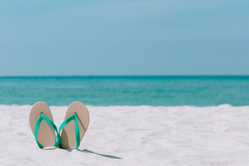Ocean landscape And sandals on the beach. Welcome summer