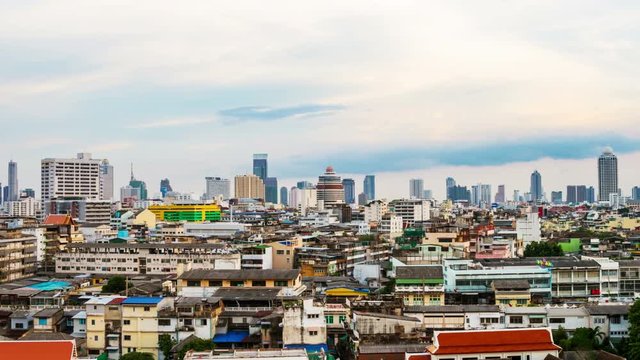 Bangkok, Thailand. Historical houses in the center of Bangkok, Thailand. Tall skyscrapers at the background in the evening with blue sky. Time-lapse at night, getting dark