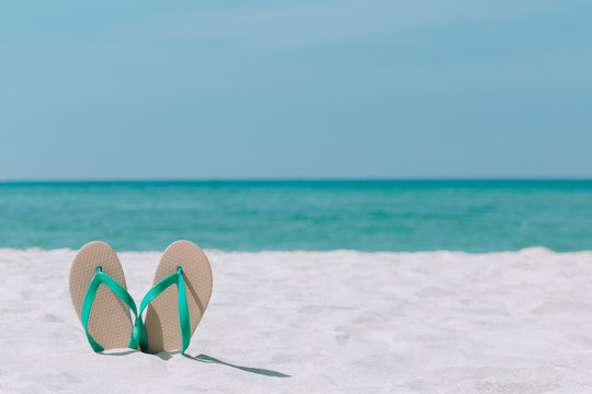 Ocean landscape And sandals on the beach. Welcome summer