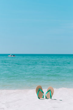 Ocean landscape And sandals on the beach. Welcome summer