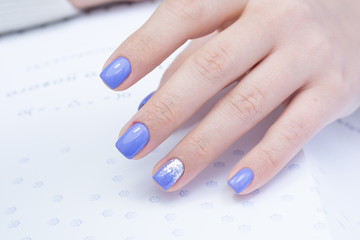 Attractive manicure on women's hands. Natural finger nails with stylish nail art.