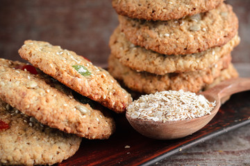 Homemade oat biscuits close-up on a plate and a spoon with oat flakes