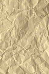 Paper beige color aged and wrinkled. Background of brown color with kinks and fraying.