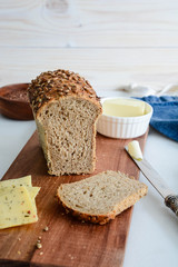 Homemade multi-grain bread with butter and cheese.