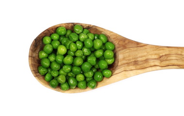 Fresh wet and raw green peas in wooden spoon, vegetable isolated on white background, top view