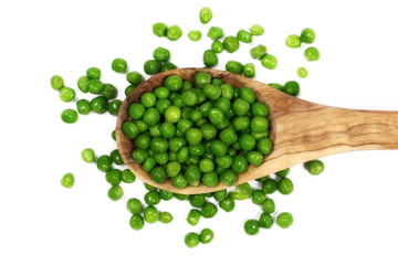 Fresh wet and raw green peas in wooden spoon, vegetable isolated on white background, top view