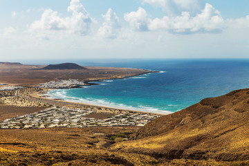 View on the Famara village, a famous surfing and kiting resort on Lanzarote, Canary Islands, Spain