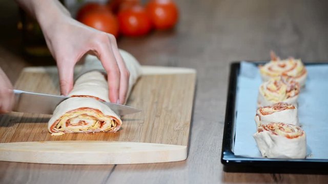 Cooking homemade Italian pizza roll on the wood table and chef