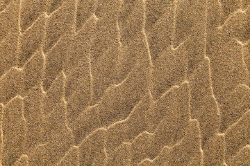 Sharp texture of sea sand forming unique waves