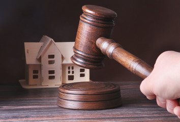 House for sale, auction hammer , symbol of authority and Miniature house . Courtroom concept.