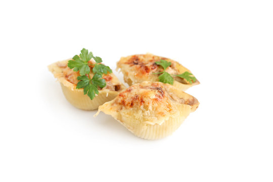 Italian pasta Conchiglioni Rigati stuffed with meat. Sprinkled with cheese. On white background