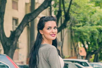 Cute girl looking over the shoulder on the street.
