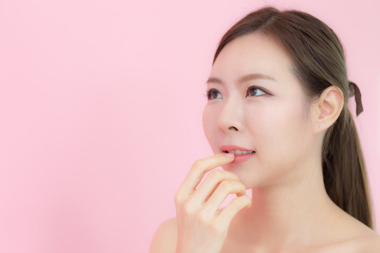 Asian beauty woman smile and looking in copy space,Mock up for display product,isolated on pink background