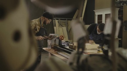 Two man in joinery workshop.
