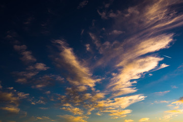 Naklejka na ściany i meble Evening blue sky background with beautiful clouds and a plane
