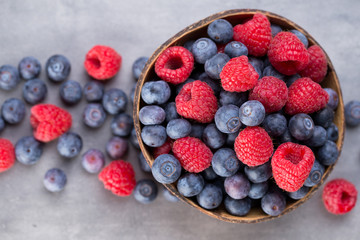 Juicy and fresh blueberries with green mint on rustic gray table.