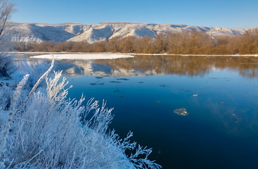 Freezing river from the hilly banks and large ice floes.