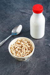 Multigrain breakfast cereal hoops in a bowl with milk