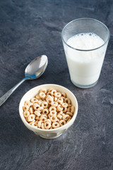 Multigrain breakfast cereal hoops in a bowl with milk