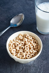 Multigrain breakfast cereal hoops in a bowl with milk