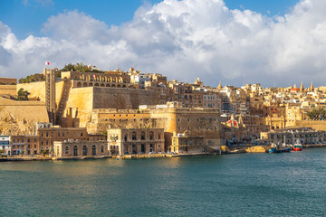 Fototapeta premium View on Valletta, capital city of Malta from the Grand Harbour with docks, The Saluting Battery and Barakka Lift.