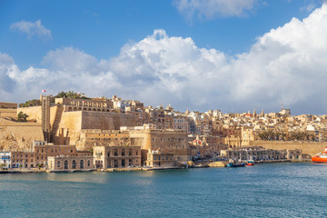 View on Valletta, capital city of Malta from the Grand Harbour with docks, The Saluting Battery and Barakka Lift.