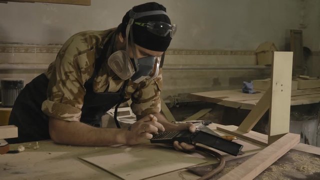 Carpenter working on a drawing, close-up, in a carpentry workshop