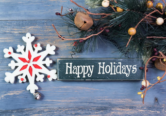 happy Holiday written on wooden background with snowflake