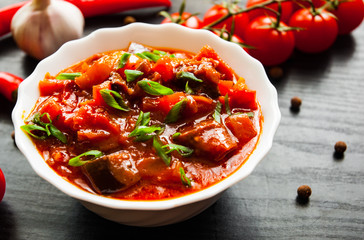 Goulash. Vegetable rague with eggplant, pepper, tomato and carrot in white bowl on dark wooden...