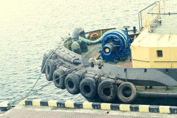A towboat moored to a pier.