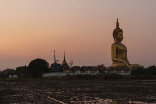 Big Buddha in Thailand with twilight sky at sunset