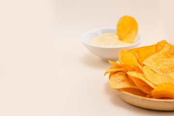 Cheese and onion potato chips with soft drink on table.