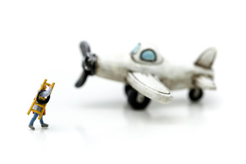 Fototapeta na wymiar Miniature people : technician, mechanic with airplane using for background.