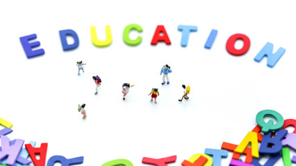 Miniature people : children and student with colorful wooden English alphabe,education concept.