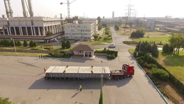 Ukraine - May 2016: Aerial view of oversized cargo truck near chemical plant