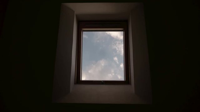 Time lapse clouds through attic window