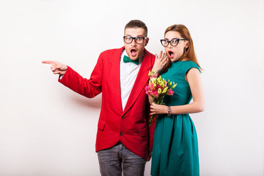 Hipster Couple In Love With A Bouquet Of Flowers In The Studio At Christmas, The Concept Of Valentine's Day