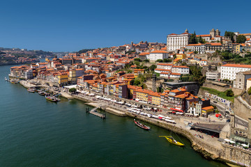 View on old town and historic centre of Porto, Oporto in Portuguese, Portugal as seen from Louis Pont Bridge. Popular touristic destination for port and wine tasting.