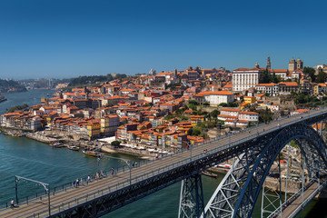 View on old town and historic centre of Porto, Oporto in Portuguese, Portugal as seen from Louis Pont Bridge. Popular touristic destination for port and wine tasting.