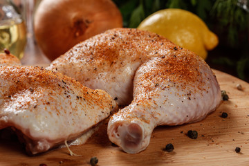 Raw chicken drumsticks seasoned with herbs