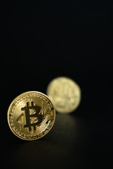 Gold Bitcoins isolated on black background