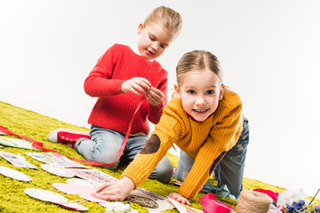 happy little sisters making diy greeting cards isolated on white