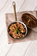Buckwheat porridge with mushrooms in the copper pan