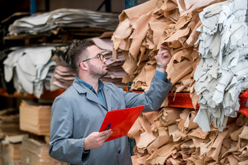 business manager at leather shoe factory doing various daily tasks