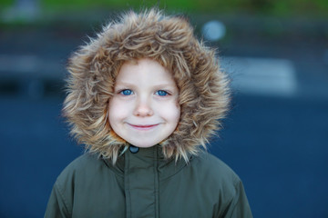 Small child in the park with a warm coat