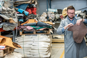 business manager at leather shoe factory doing various daily tasks