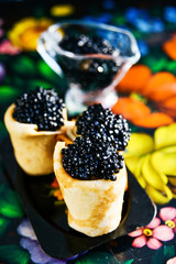 Russian Maslenitsa, pancakes with black caviar. Shrovetide, pancake week, carnival, shrove, pancake day.