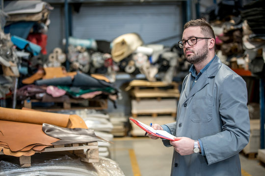 business manager at leather shoe factory doing various daily tasks