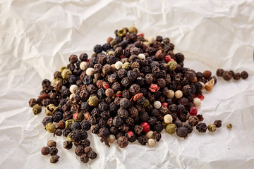 sweet-scented black pepper peas in bulk on white crumpled paper. top view
